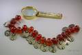 Moroccan Amber and Coin Necklace and a Barlow Brass and Ivoryhandled Magnifier