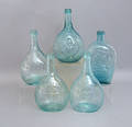Five aqua glass bottles