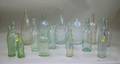 Sixteen Colorless and Aqua Glass Beverage and Spring Water Bottles
