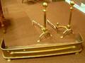 Pair of Neoclassical Brass Balltop Fluted Post Andirons and a Brass Fireplace Fender