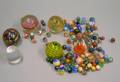 Six Colorless and Internally Decorated Paperweights and Bag of Marbles
