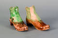 Two tortoiseshell glaze Staffordshire boot form match holders ca 1800