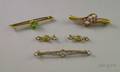 Three Gold and Gemstone Bar Pins and a Pair of Lingerie Pins