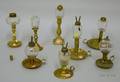Eight Colorless Glass Peg Lamps on Brass Candlestick Bases