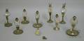 Nine Colorless Glass Peg Lamps on Pewter Candlestick Bases