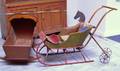 Pine Hooded Cradle a Childs Painted Sleigh and a Horse Toy