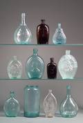 Eleven Aqua Amber and Olive Blown and Molded Glass Whiskey Flasks and Calabash Bottles