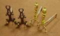 Pair of Brass Ringturned Andirons and a Pair of Cast Iron Scrollform Andirons with Dolphin Feet