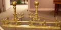Pair of Brass Balltop and Ringturned Andirons and a Brass Fireplace Fender