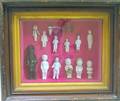 Fifteen Small China Dolls in a Walnut Shadow Box