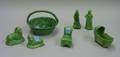 Staffordshire Green Glazed Basket a Pair of Lions a Figural Chair Cradle Woman and Cherub