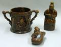 Rockingham Brown Glazed Mermaid Flask Large TwoHandled Cup and a Figural Bottle