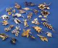 Twentyfive Mostly Sterling Silver and Goldfilled Floriform Brooches
