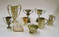 Nine Pewter Copper and Silver Plated Trophy Articles