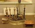 Two Pairs of Brass Urntop Andirons a Brass Serpentine Openwork Fireplace Fender a Wrought Iron Hearth Shovel