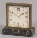 Desk clock Square dial trimmed in brass raised on a variegated stone plinth eight day movement ht 5 wd 5 in Grogan Co Swi