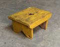 Yellow painted foot stool with heart cutout