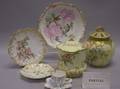 Twentynine European Gilt and Handpainted Porcelain Jars Plates Cups and Saucers