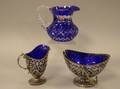 Pairpoint Silver Plated and Cobalt Blue Glasslined Sugar and Creamer and a Cobalt CuttoClear Glass Jug