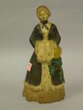 Painted Cast Iron Woman in an Ermine Trimmed Coat and Muff Doorstop