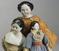 Three BrownEyed China Head Dolls