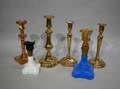 Four Brass and Bellmetal Candlesticks and a Pair of Colored Glass Makedo Candlesticks