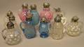 Twelve Victorian Colored and Colorless Art Glass Syrup Pitchers
