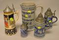German Cobalt Highlighted Stoneware Motto Pitcher and Four German Stoneware Steins