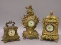 Three Rococostyle Gilt Cast Metal Figural and Case Timepieces