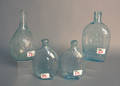 Four aqua glass bottles
