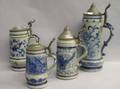 Four German Pewter Lidded Cobalt Decorated Molded Stoneware Steins