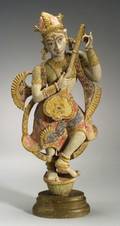 Carved and Painted Indian Figure of a Divinity Tuning a Sitar