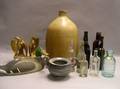Stoneware Jug a Painted Carved Wooden Duck Decoy a Pair of Giltwood Eagle Bookends Nine Assorted Bottles and a Pewter Sugar