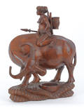 Southeastern Asian carved wooden figure of a water buffalo and rider
