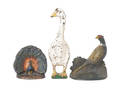 Three cast iron doorstops to include duck