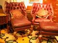 Pair of Charles Pollock Rococostyle Tufted Leather Upholstered Carved Beech Wing Chairs and Ottoman