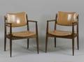 Pair of Modern Upholstered Walnut Armchairs chairs with caramelcolored upholstered vinyl seat and back shaped arms and tapered legs