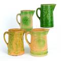 Four green glaze stoneware pitchers