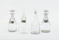 Four colorless glass decanters