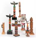 Seven carved Native American totem poles