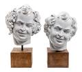 Two White Glazed Terra Cotta Heads of Bacchus
