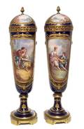 A Pair of Sevres Porcelain Lidded Urns