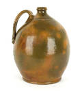 Large earthenware jug with green and ochre glazing 19th c