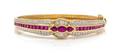 An 18 Karat Yellow Gold Ruby and Diamond Bangle Bracelet