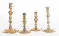 Four Queen Anne brass and bellmetal candlesticks mid 18th c