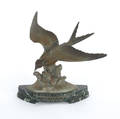 Patinated white metal bird sculpture
