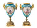 A Pair of Sevres Style Gilt Bronze Mounted Porcelain Urns