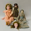 Three Bisque and Composition Dolls a Bisque Doll Head and a Trunk of Doll Clothing