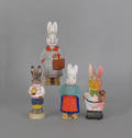 Four composition figural rabbit candy containers