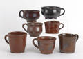 Seven Pennsylvania redware mugs 19th c